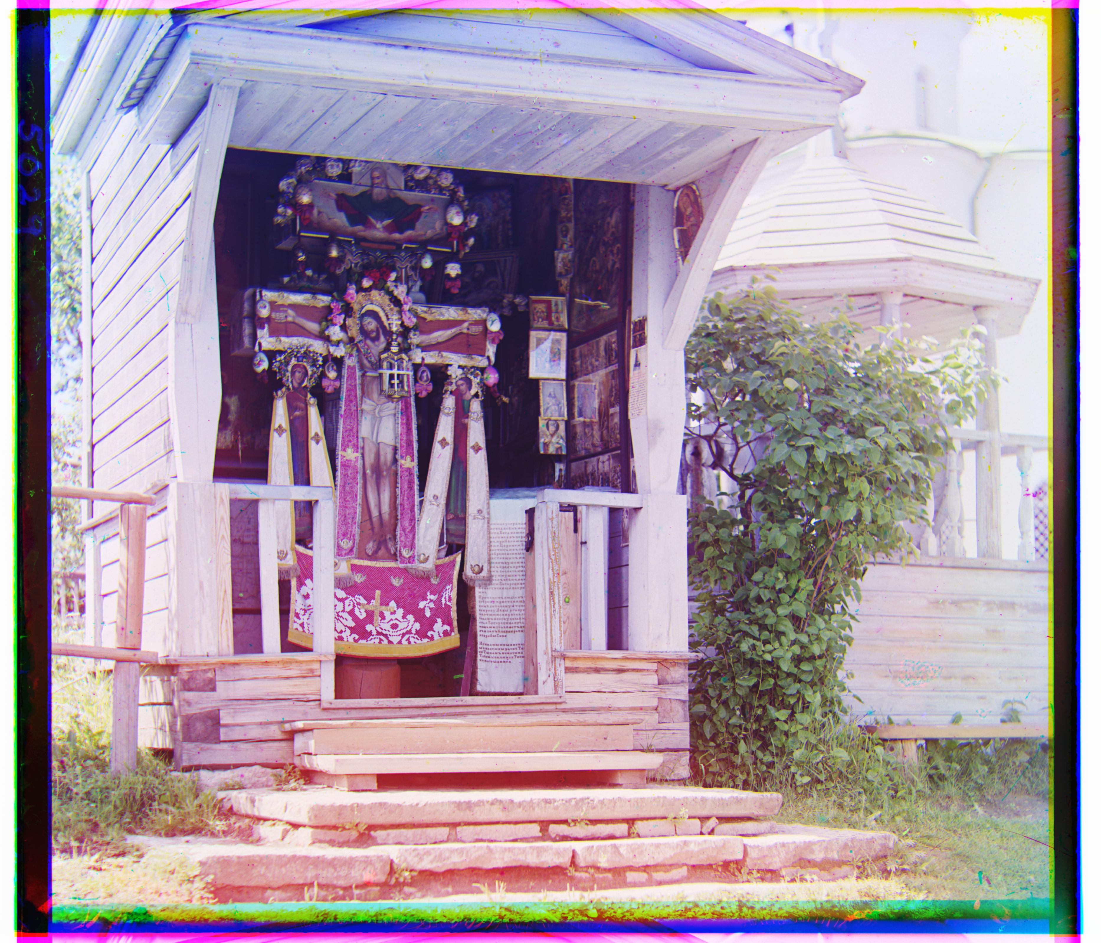 Jesus on a Cross in front of a House