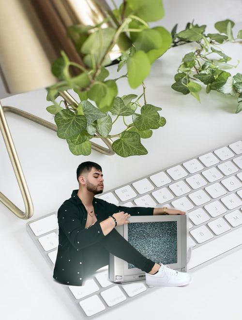 Man with TV on keyboard blended